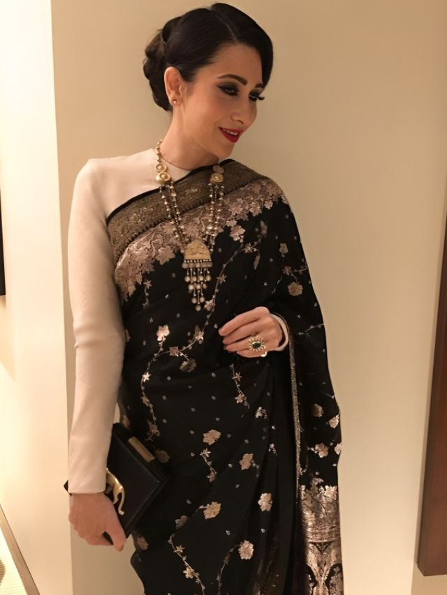 Karisma Kapoor in Black Saree with Side Parted Bun Hairstyle